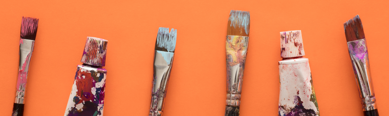 Paint brushes on salmon background