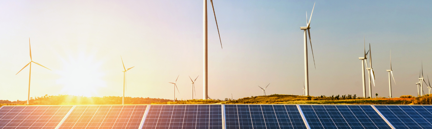 Image of windmills with a sunset background.