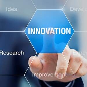 A person pressing a button that says the word innovation.