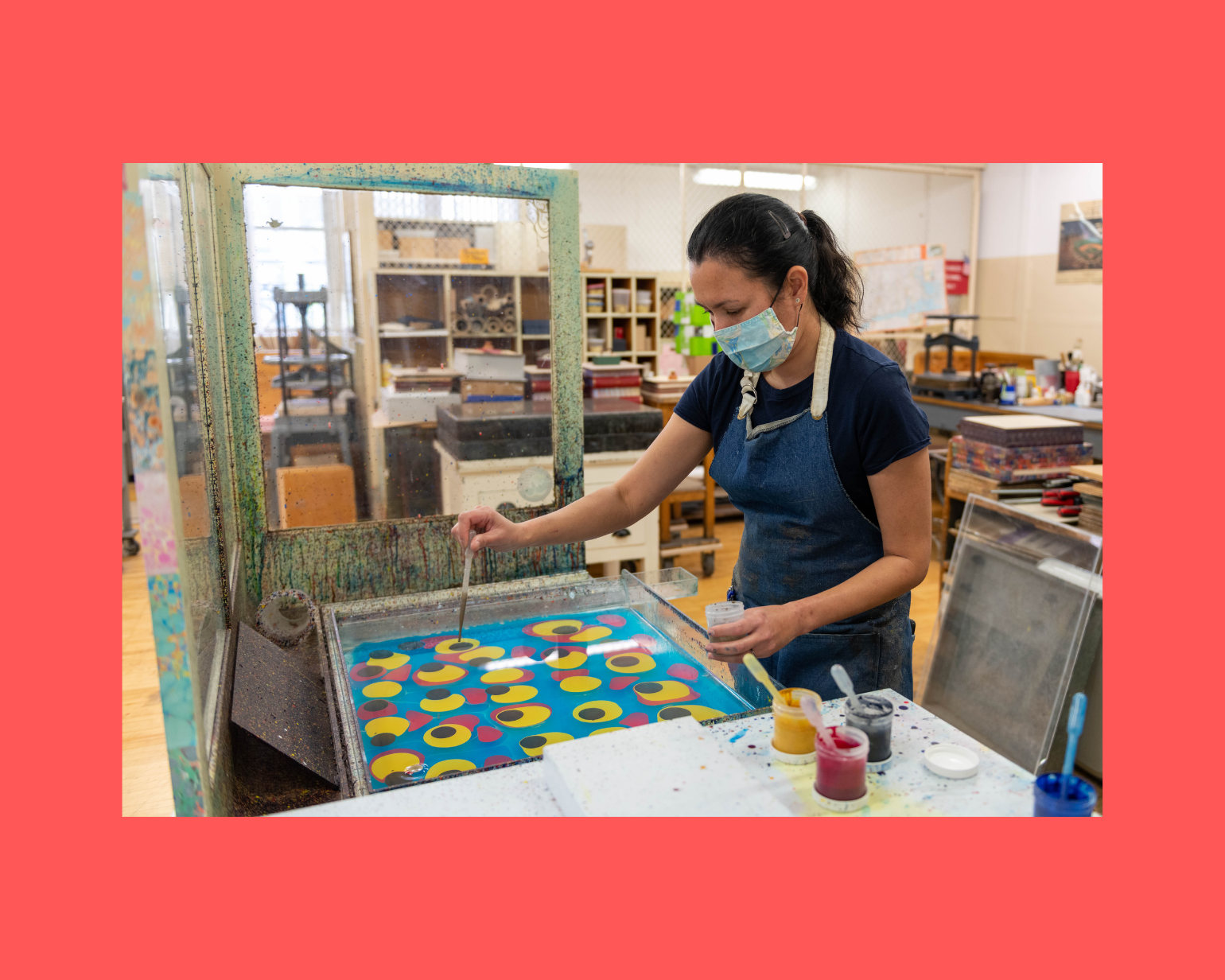 Image of Sarah marbling paints and wearing a smock.