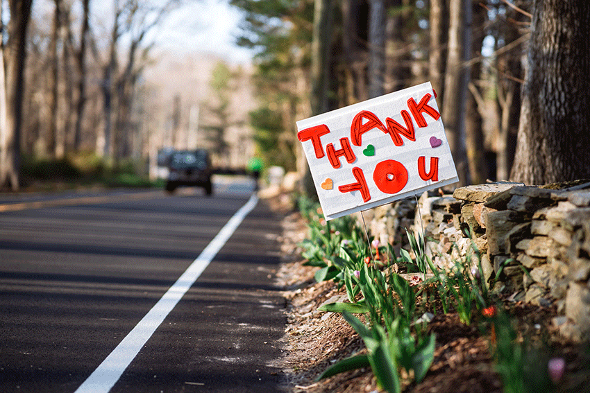 Sign near road that reads thank you